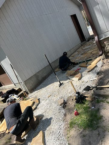 Bison crew installing a flagstone walkway between two homes
